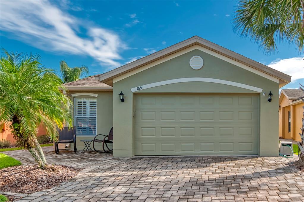 165 Rialto Road Poinciana, FL 34759 - Photo 1 of 1 a front view of a house with garden