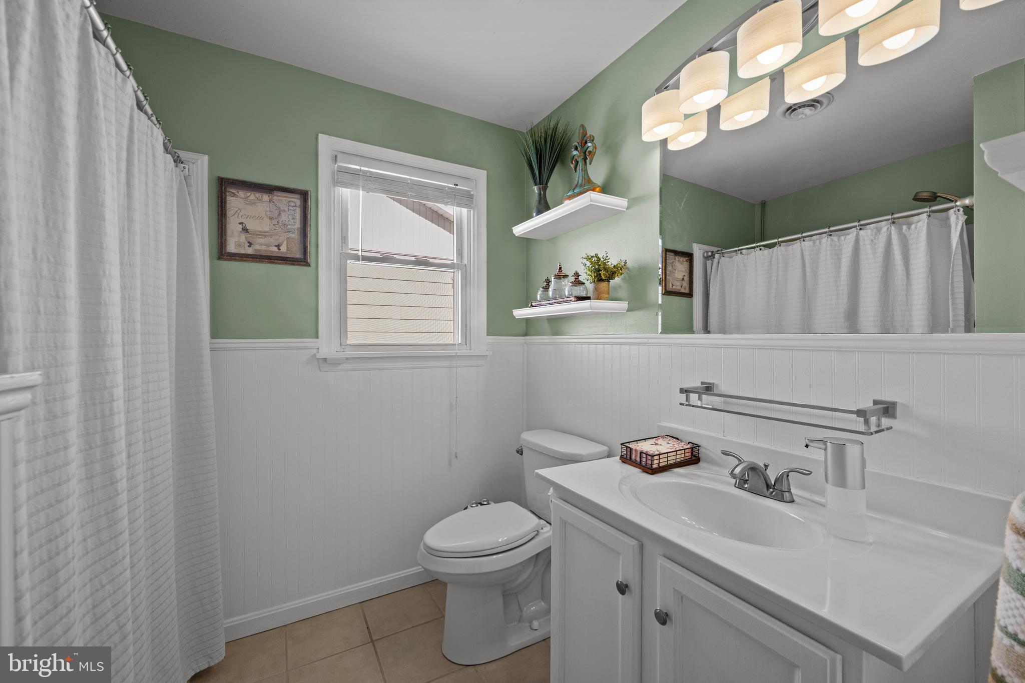 6226 2nd Avenue Hanover, MD 21076 - Photo 21 of 48 a bathroom with a toilet a sink and mirror