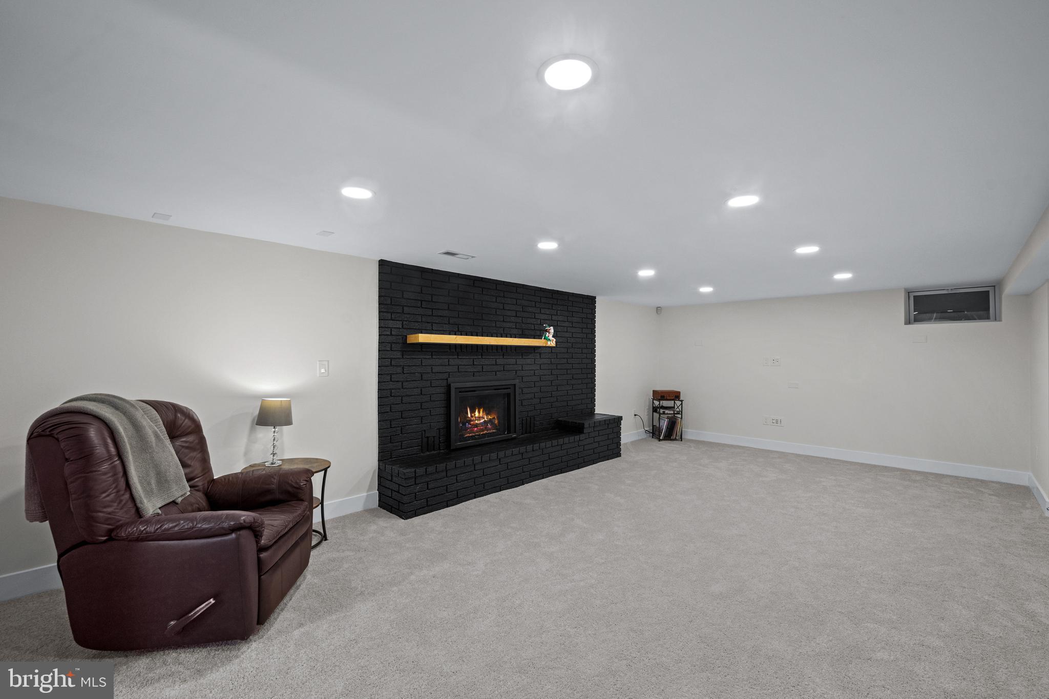 6226 2nd Avenue Hanover, MD 21076 - Photo 22 of 48 a living room with furniture and a fireplace
