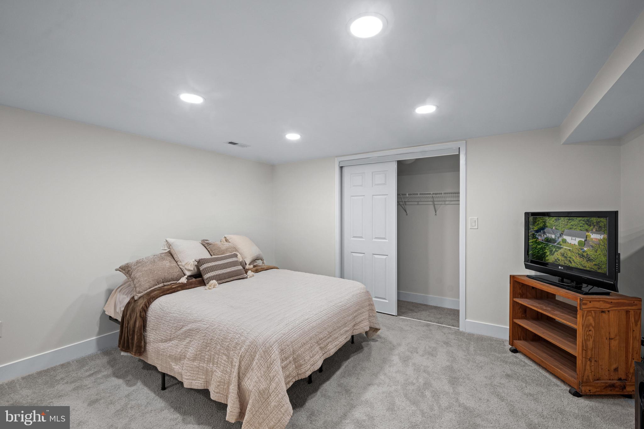 6226 2nd Avenue Hanover, MD 21076 - Photo 25 of 48 a spacious bedroom with a bed and flat screen tv