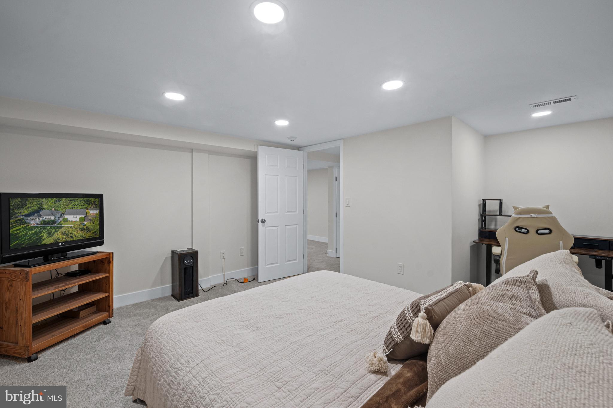 6226 2nd Avenue Hanover, MD 21076 - Photo 26 of 48 a bedroom with a bed and a flat screen tv