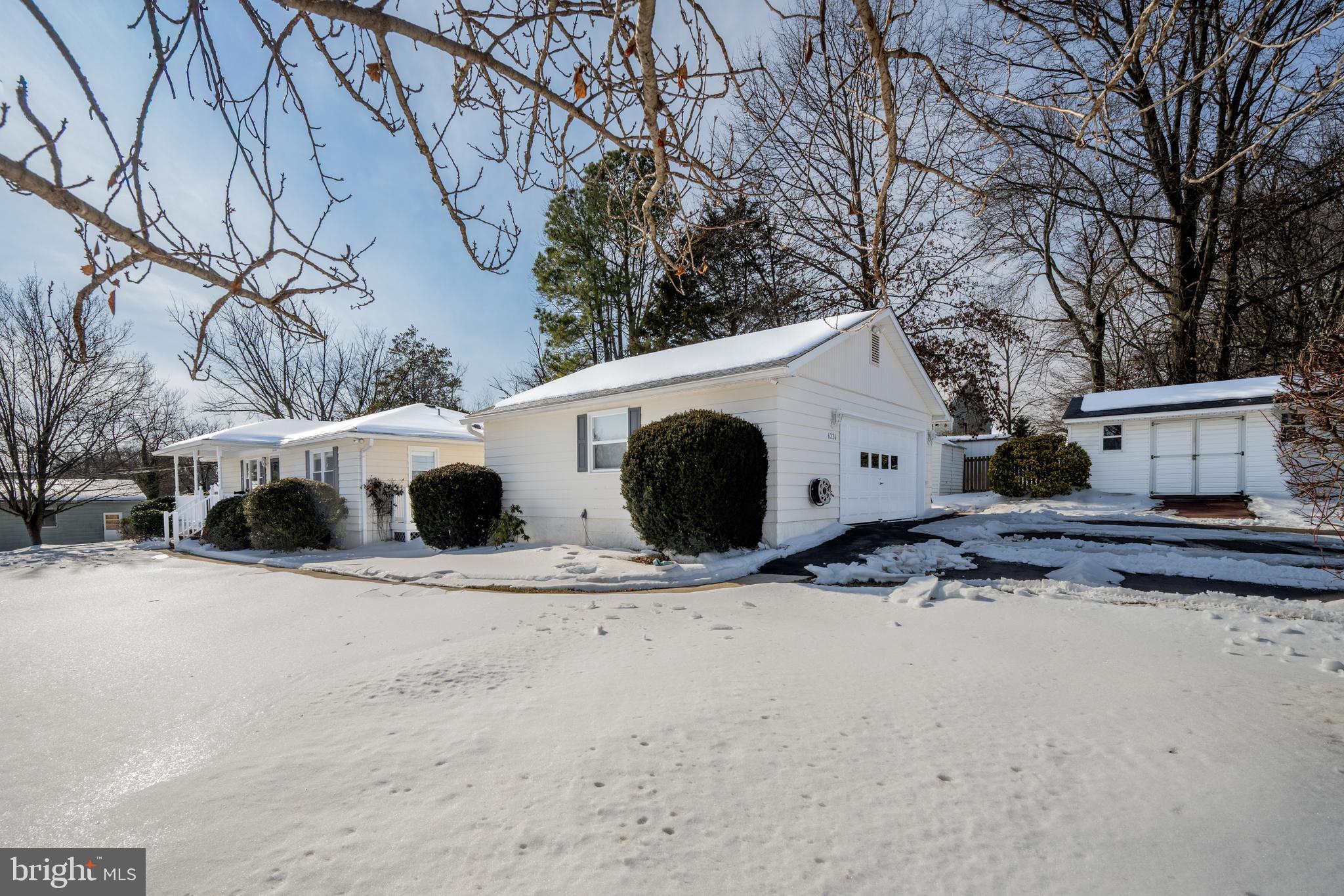 6226 2nd Avenue Hanover, MD 21076 - Photo 35 of 48 a view of a white house with a yard covered in snow
