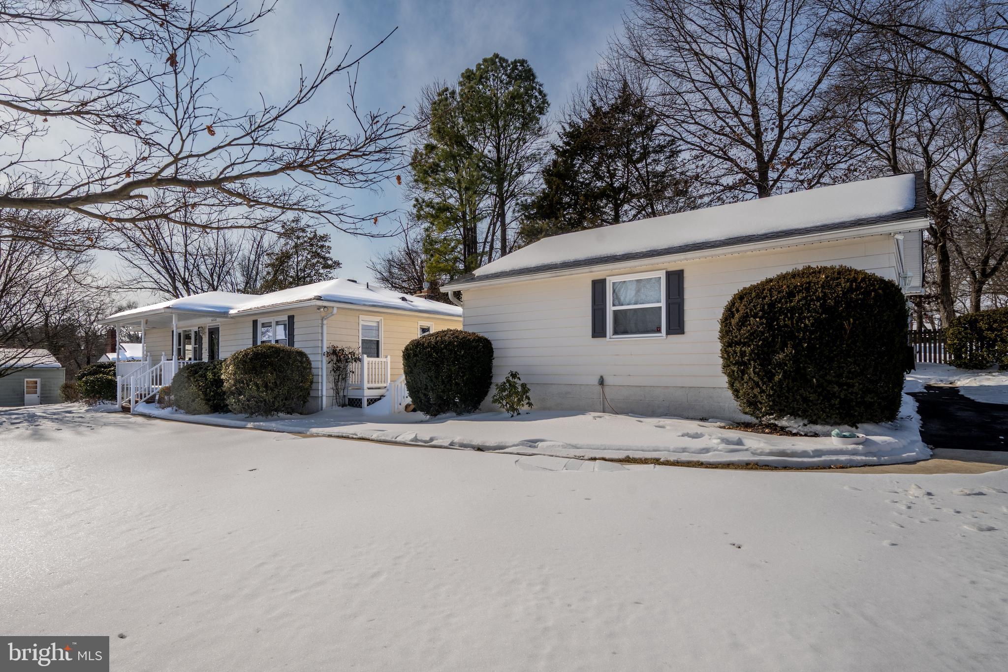 6226 2nd Avenue Hanover, MD 21076 - Photo 36 of 48 a front view of a house with a yard covered in snow