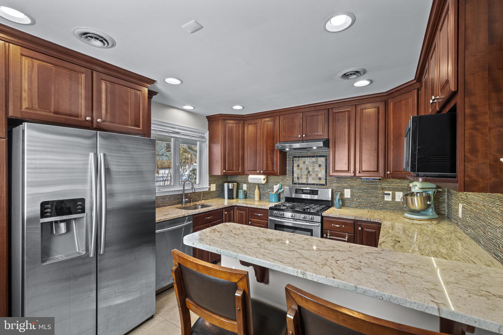 6226 2nd Avenue Hanover, MD 21076 - Photo 6 of 48 a kitchen with stainless steel appliances granite countertop a sink refrigerator and cabinets