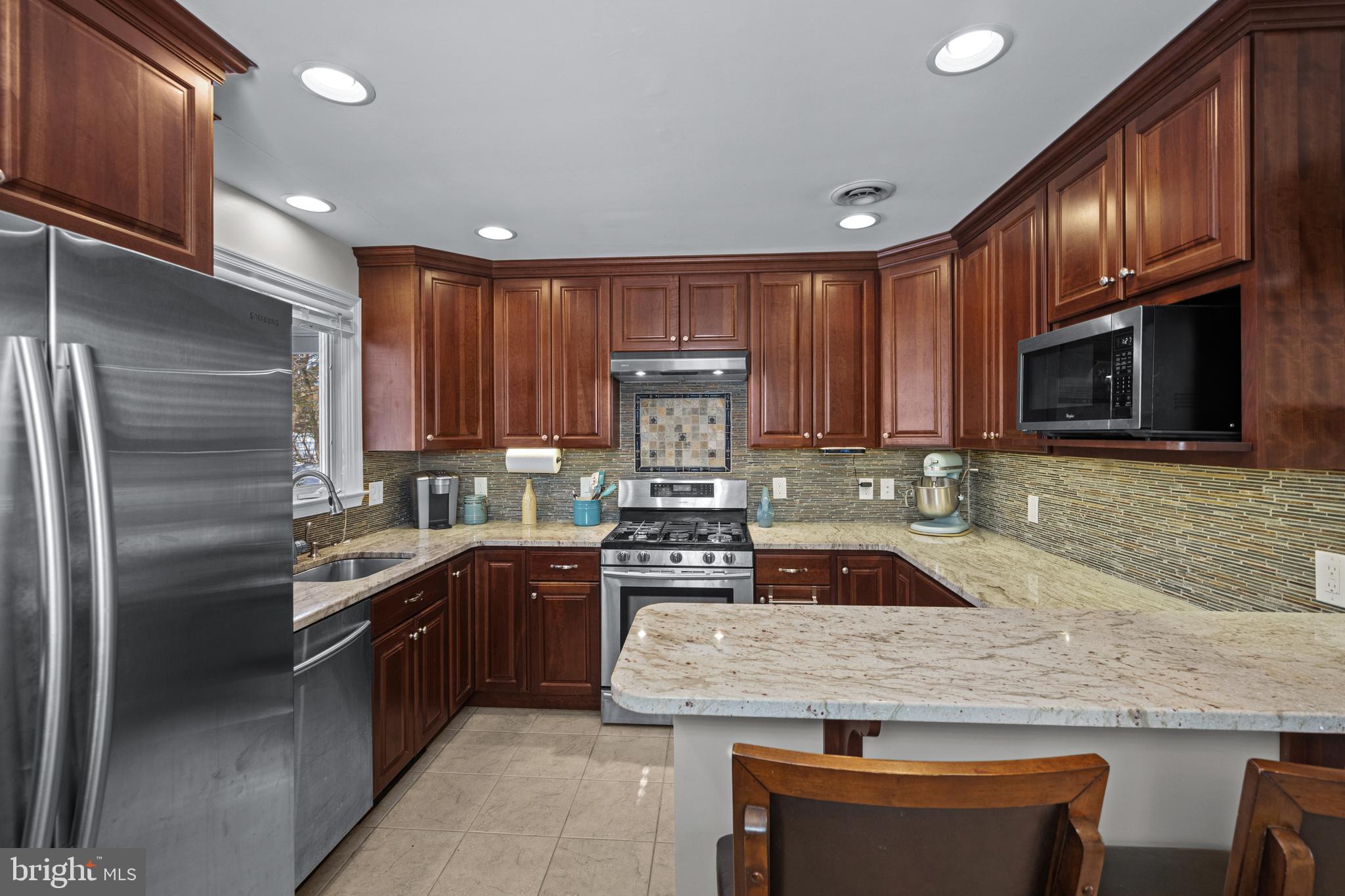 6226 2nd Avenue Hanover, MD 21076 - Photo 7 of 48 a kitchen with granite countertop a sink stainless steel appliances and cabinets