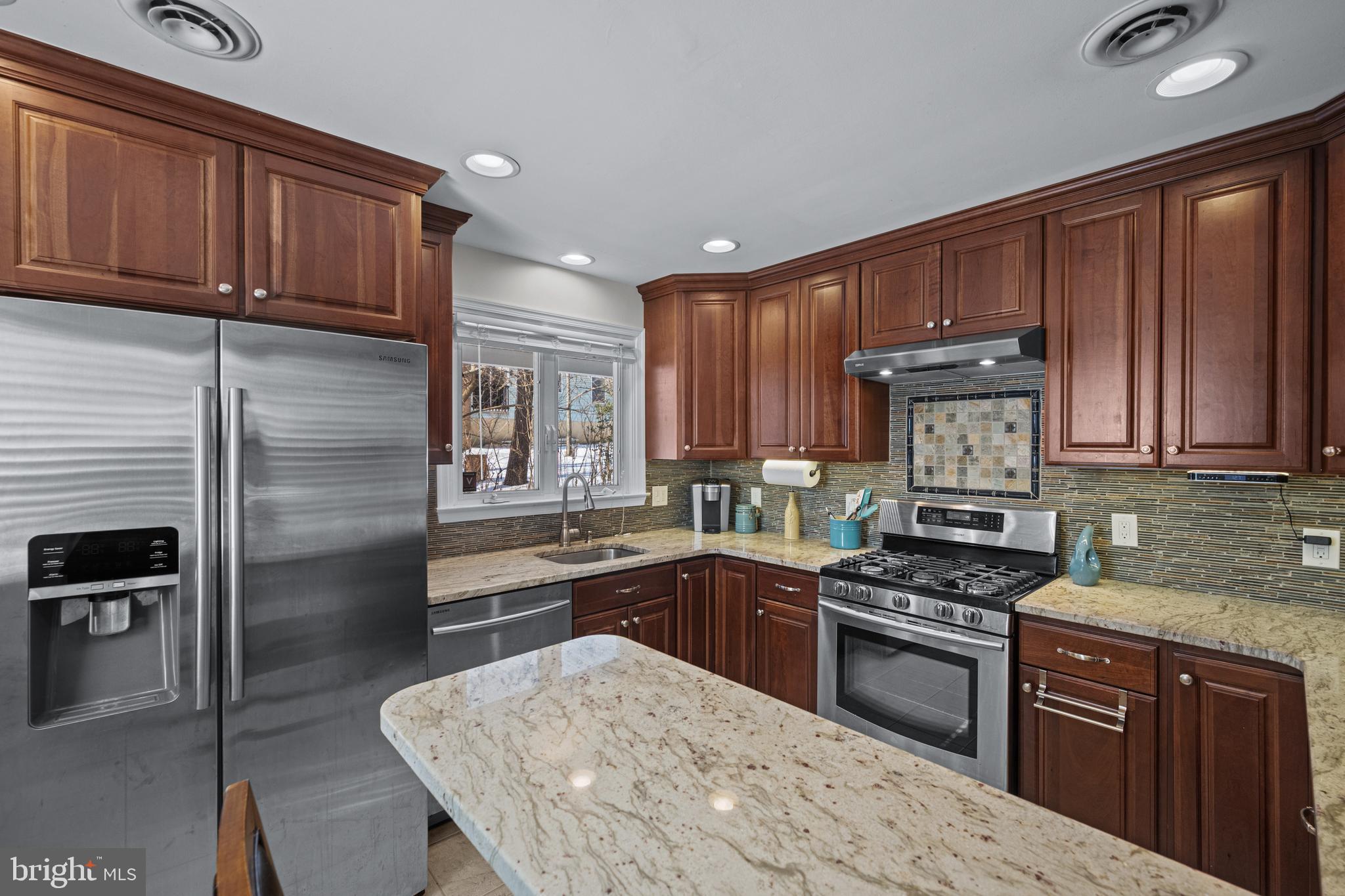 6226 2nd Avenue Hanover, MD 21076 - Photo 8 of 48 a kitchen with stainless steel appliances granite countertop a stove refrigerator sink and cabinets