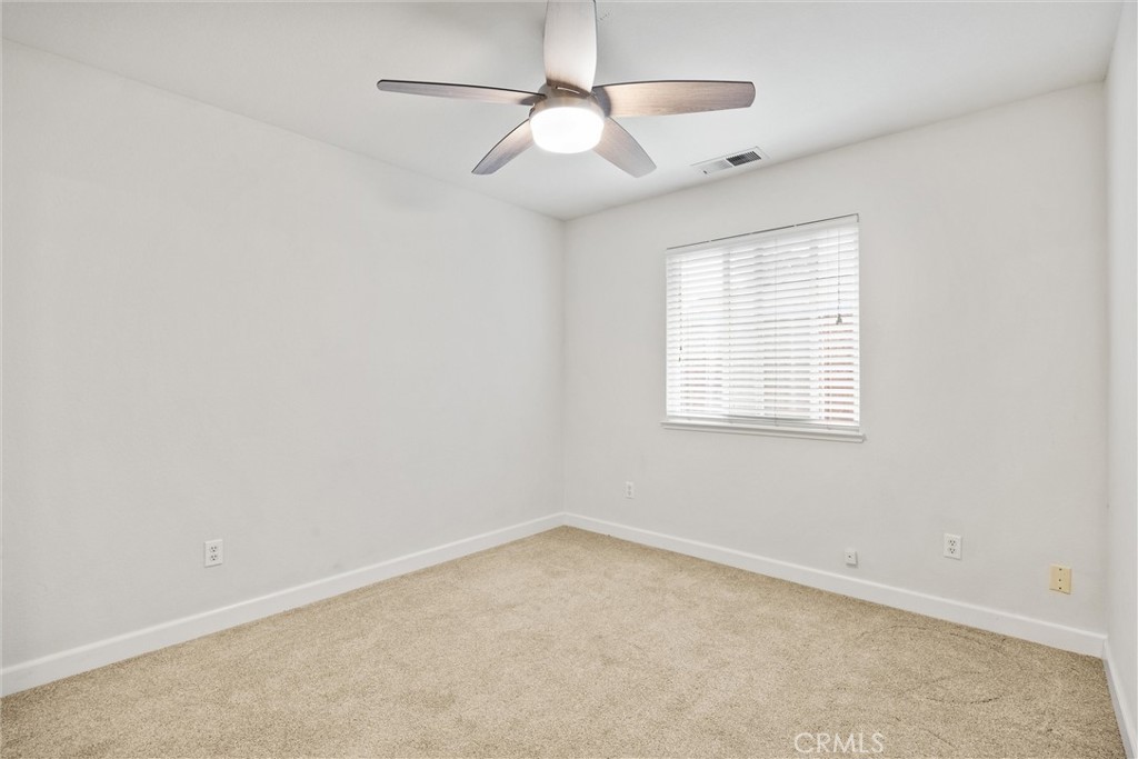 1165 Fig Street Corning, CA 96021 - Photo 21 of 46 an empty room with a window and a fan