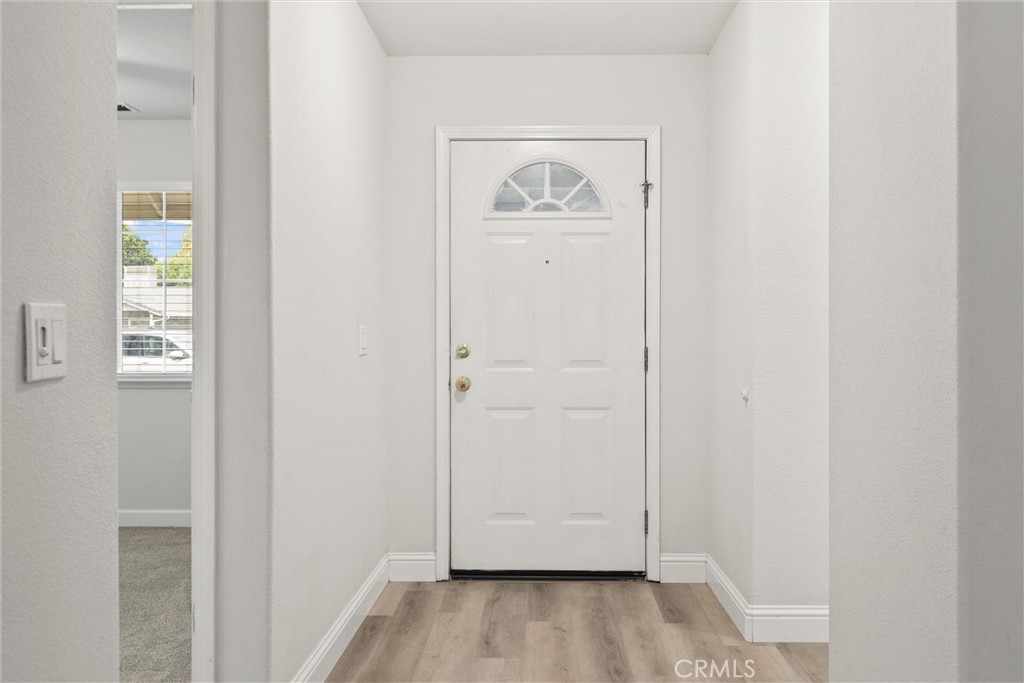 1165 Fig Street Corning, CA 96021 - Photo 4 of 46 a view of a hallway with wooden floor