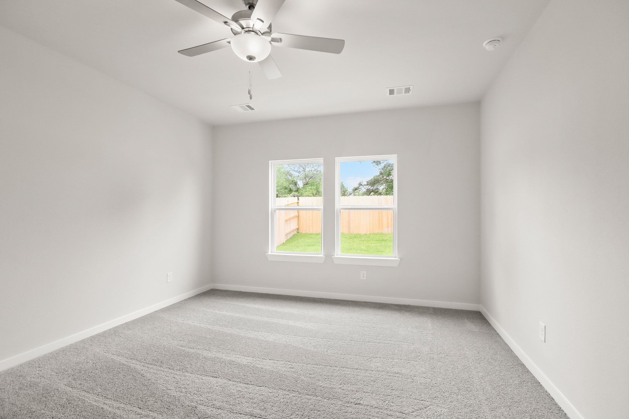 229 Spring Drive Hockley, TX 77447 - Photo 10 of 26 an empty room with a window and a fan