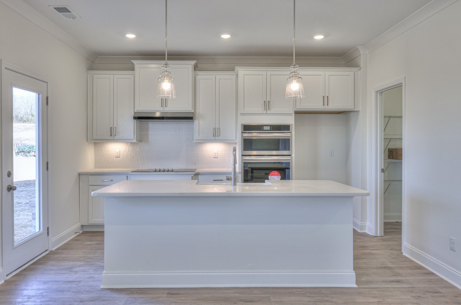 1033 Bluestem Road Columbia, TN 38401 - Photo 13 of 36 a large kitchen with stainless steel appliances a large counter top a stove and a refrigerator with wooden floor
