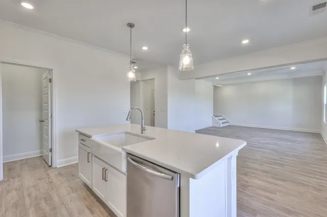 a view of a sink and a refrigerator in a room