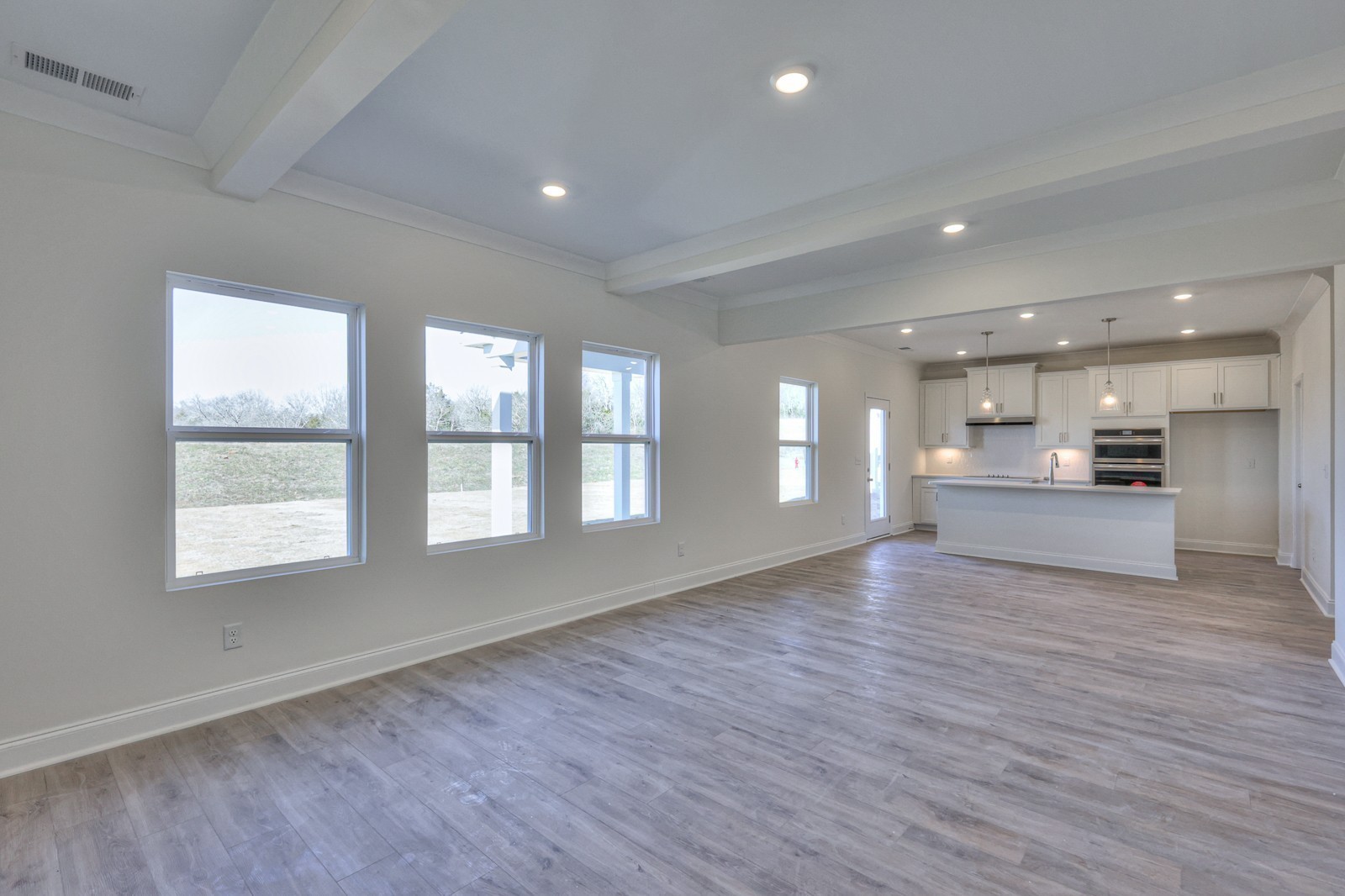 1033 Bluestem Road Columbia, TN 38401 - Photo 20 of 36 an empty room with wooden floor and windows