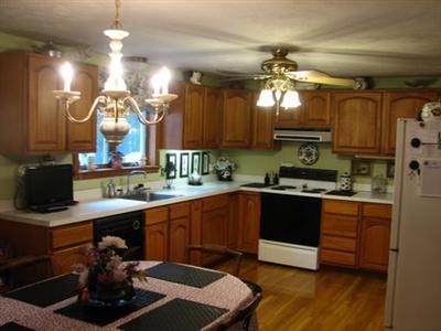 Undisclosed Address Dennis, MA 02638 - Photo 3 of 8 a kitchen with kitchen island granite countertop a sink cabinets and stainless steel appliances