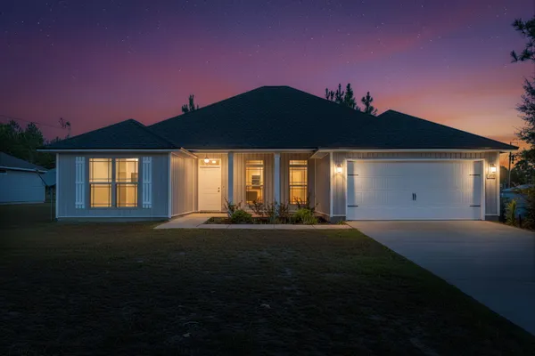 a front view of a house with a garden