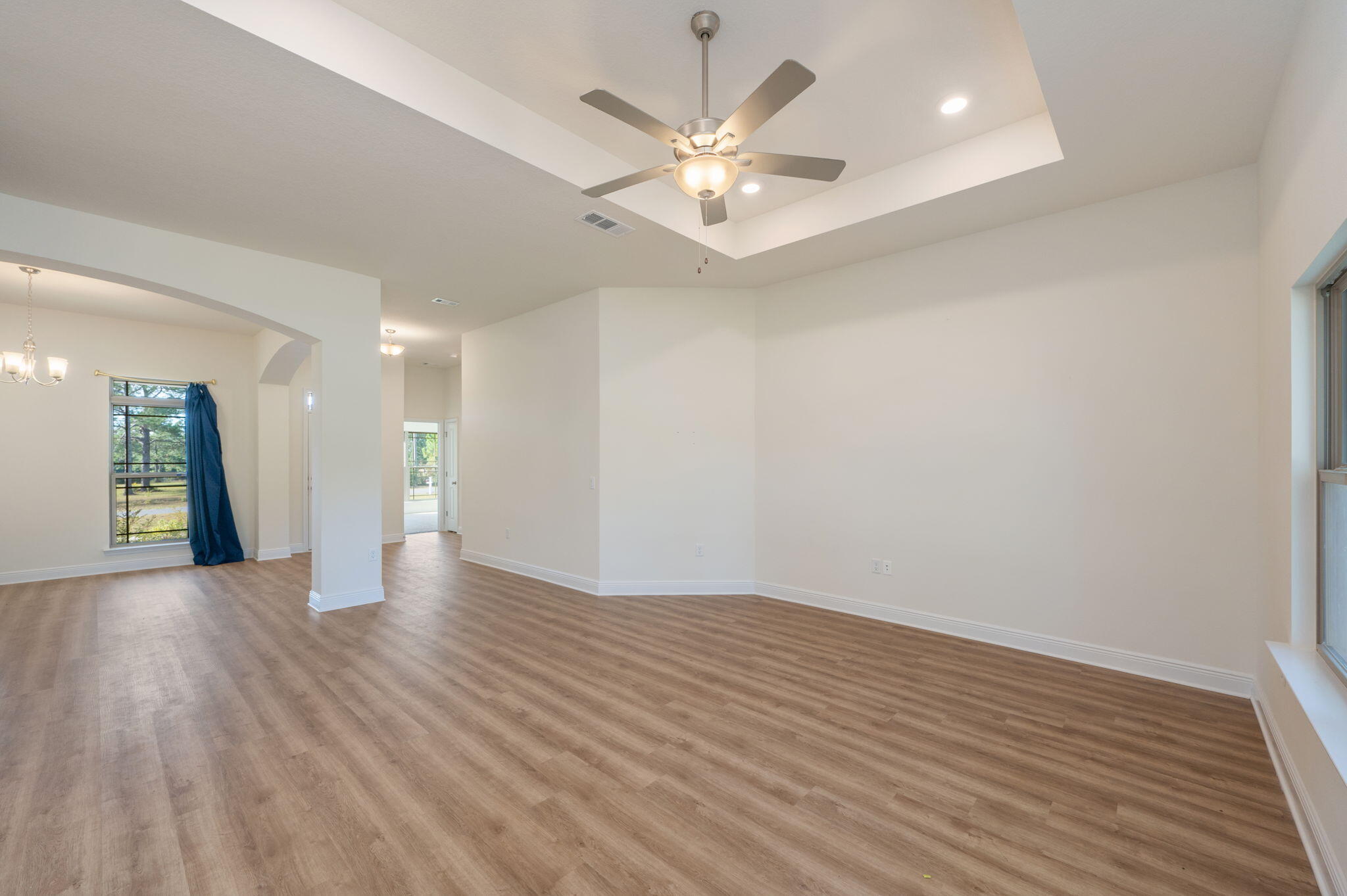 10152 American Farms Road Milton, FL 32583 - Photo 11 of 49 a view of an empty room with wooden floor