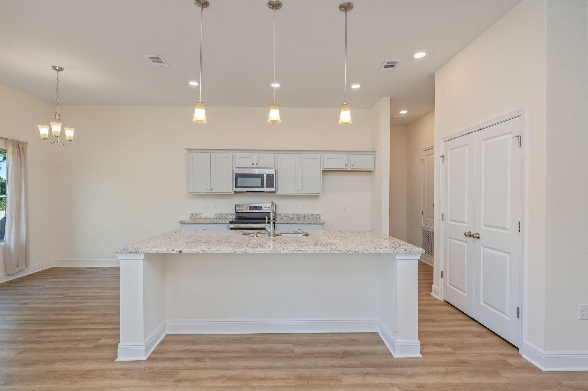 10152 American Farms Road Milton, FL 32583 - Photo 13 of 49 a view of kitchen with stainless steel appliances granite countertop cabinets and wooden floor