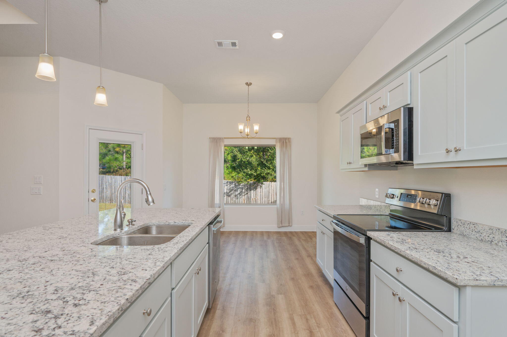 10152 American Farms Road Milton, FL 32583 - Photo 15 of 49 a kitchen with stainless steel appliances granite countertop sink stove and refrigerator