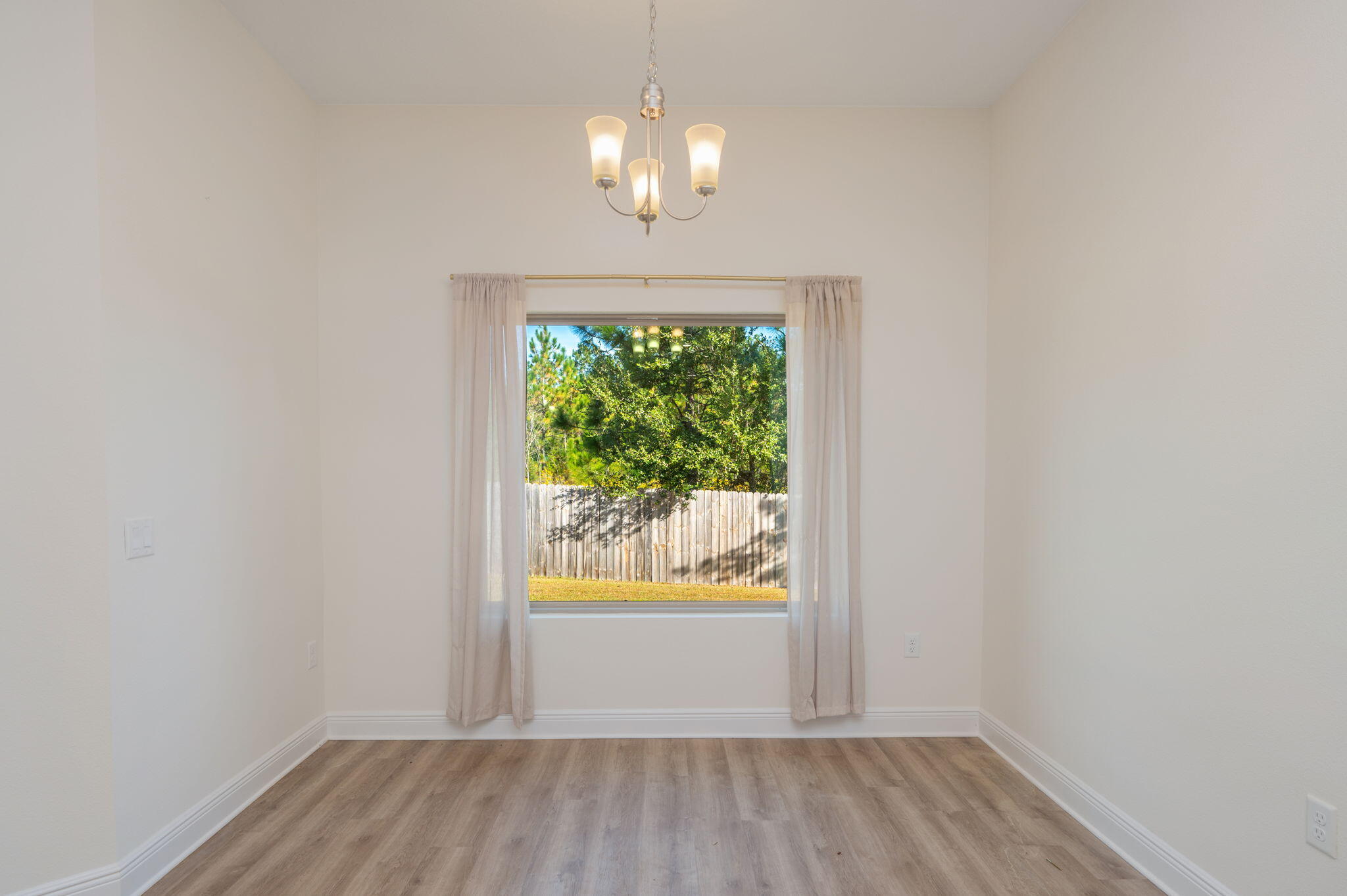 10152 American Farms Road Milton, FL 32583 - Photo 17 of 49 wooden floor in an empty room with a window