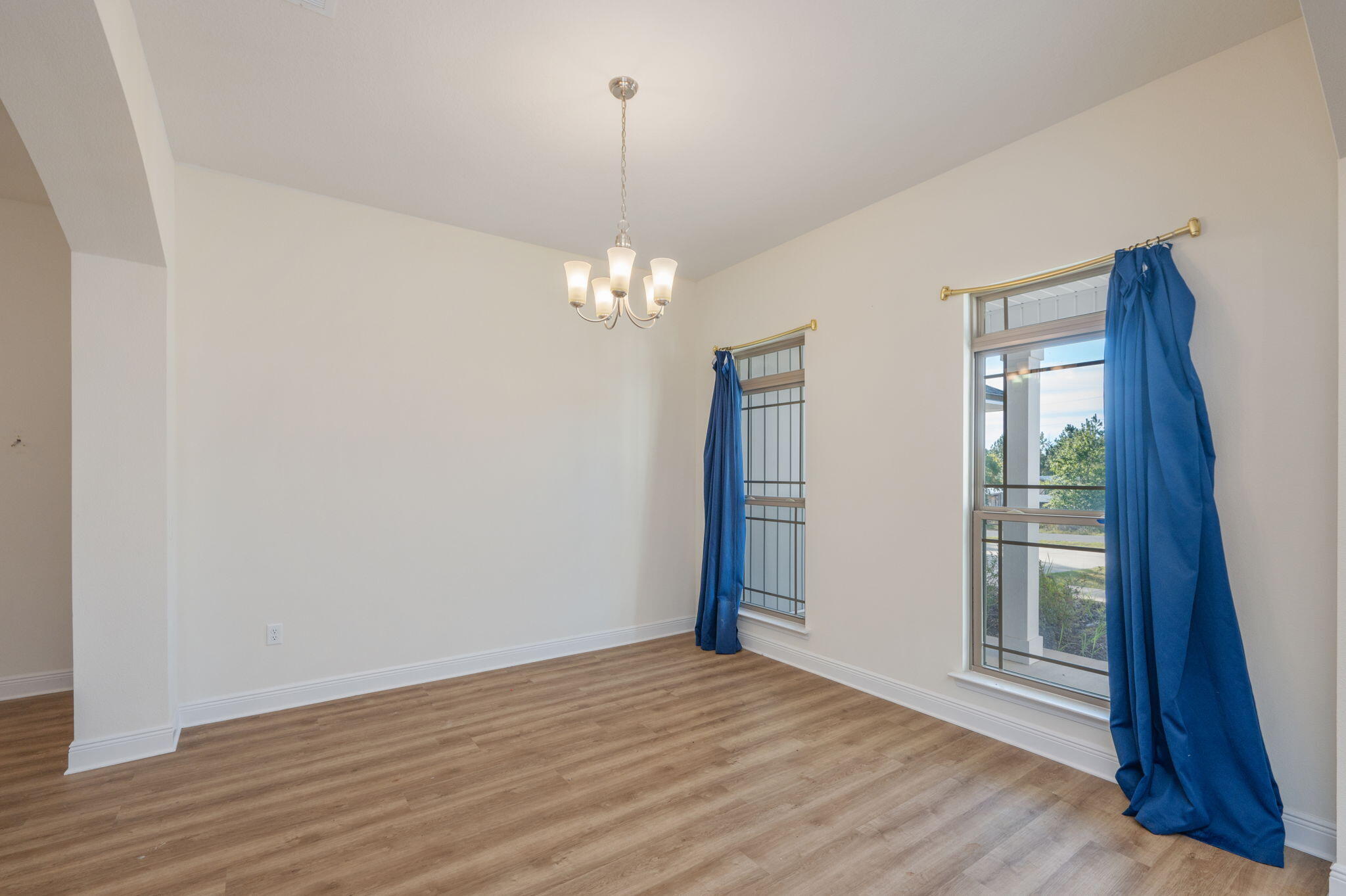 10152 American Farms Road Milton, FL 32583 - Photo 19 of 49 a view of empty room with wooden floor and fan
