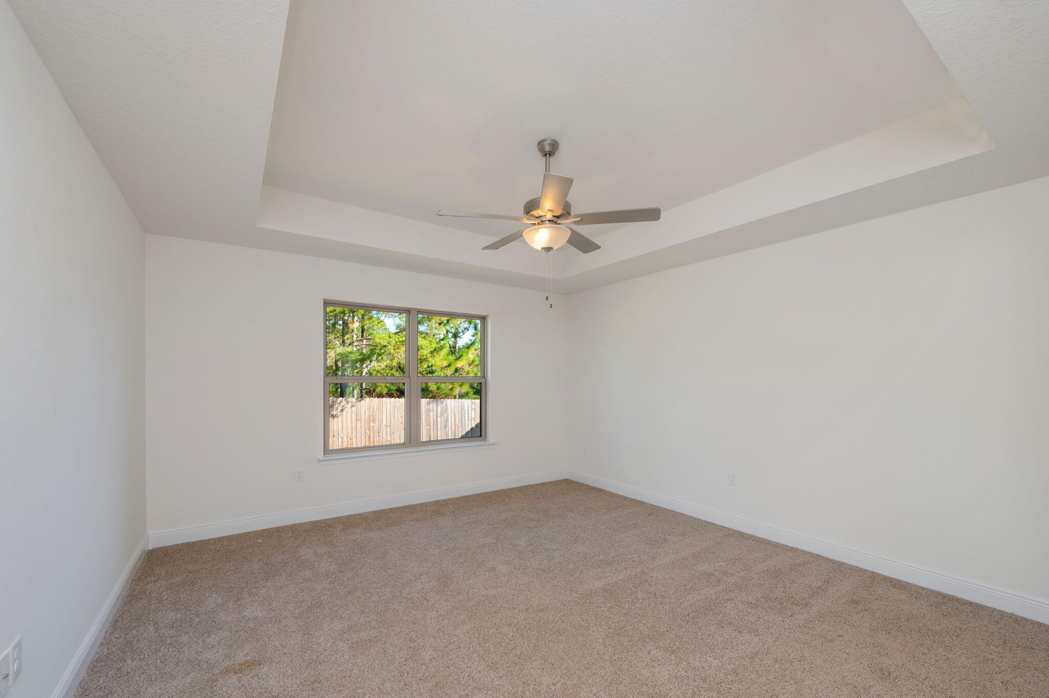 10152 American Farms Road Milton, FL 32583 - Photo 20 of 49 an empty room with windows and chandelier fan