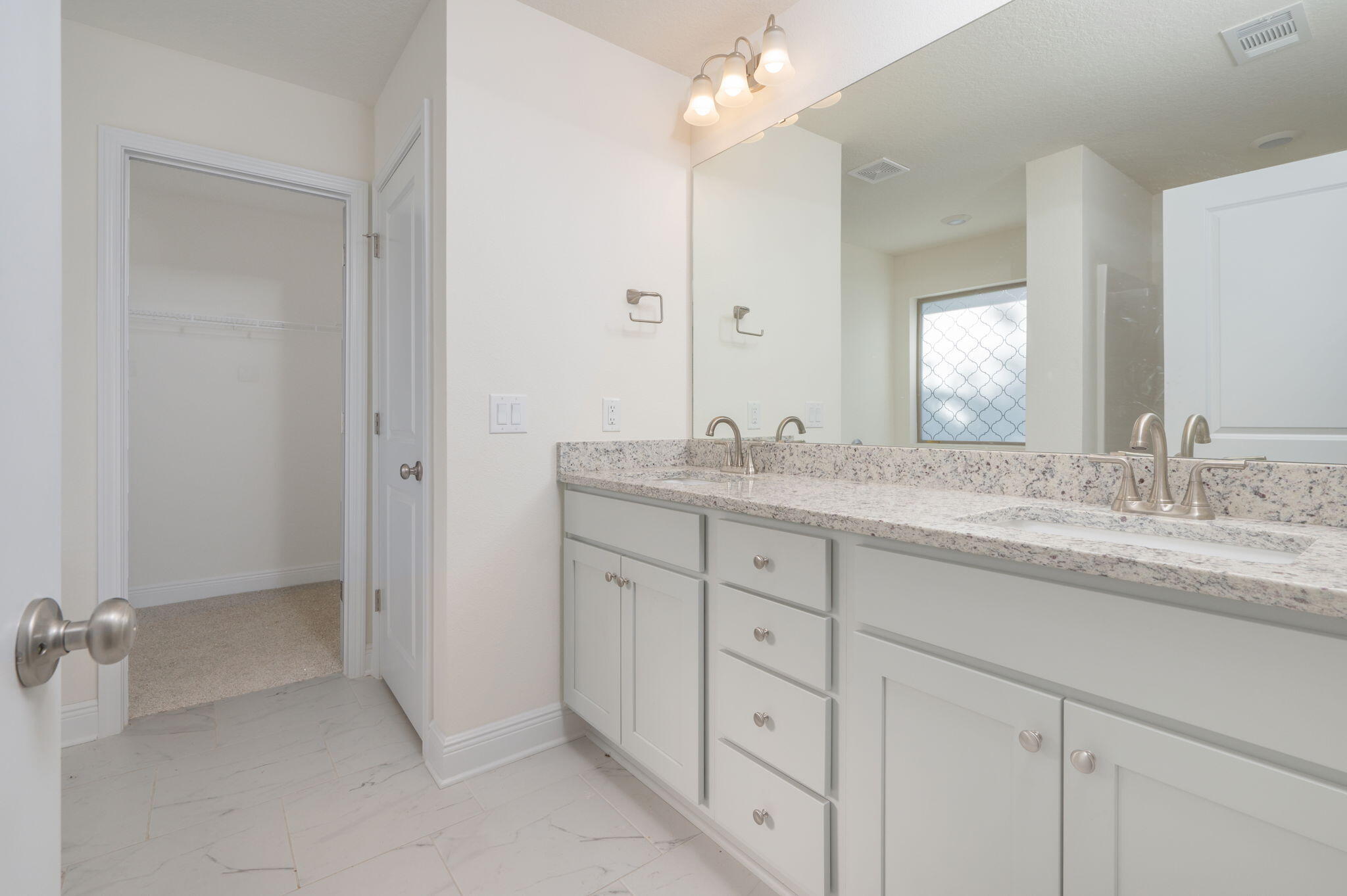 10152 American Farms Road Milton, FL 32583 - Photo 23 of 49 a bathroom with double sink and a mirror
