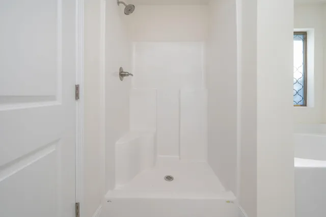 a white bath tub sitting next to a window