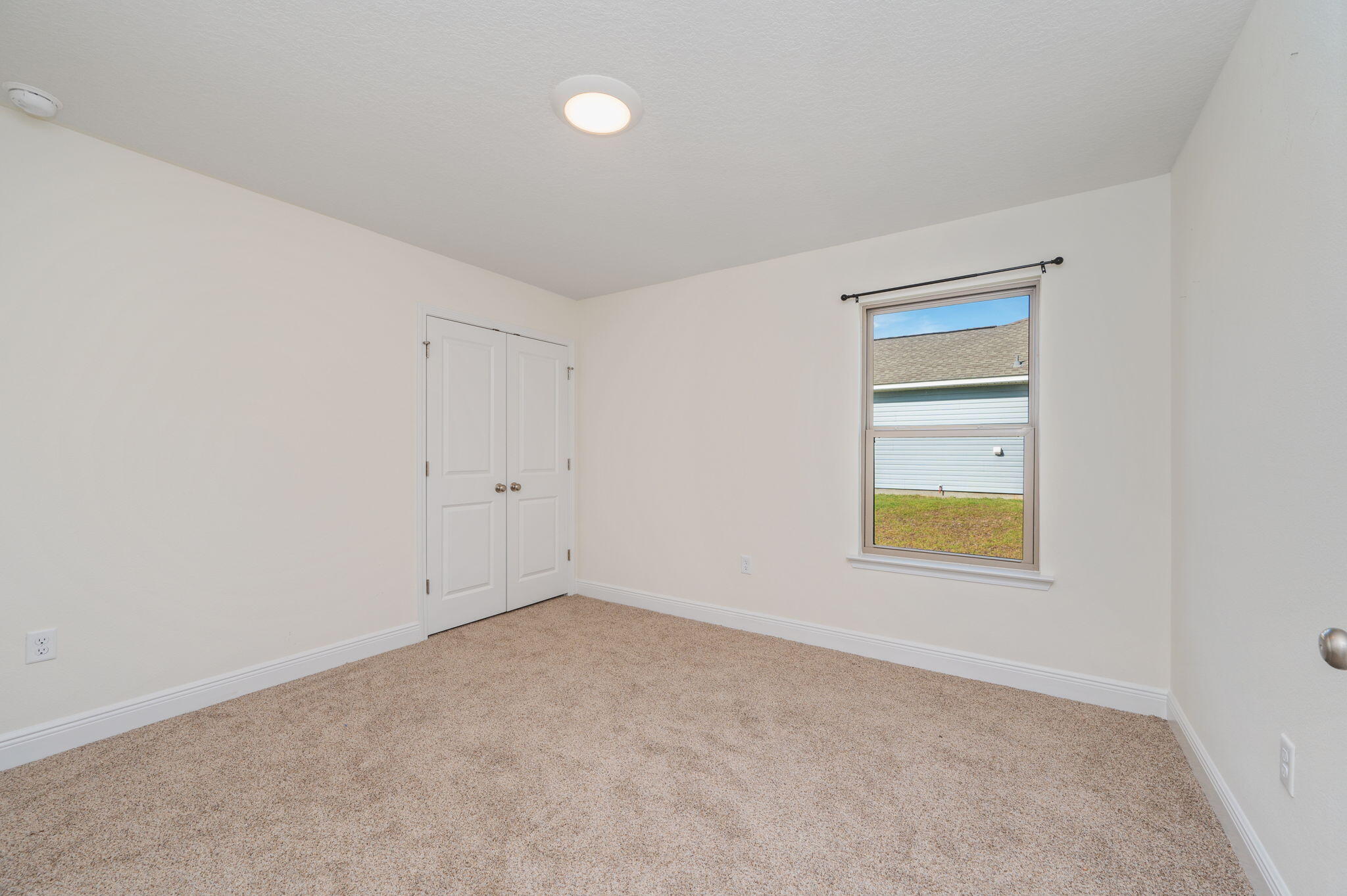 10152 American Farms Road Milton, FL 32583 - Photo 28 of 49 a view of an empty room with a window and closet area