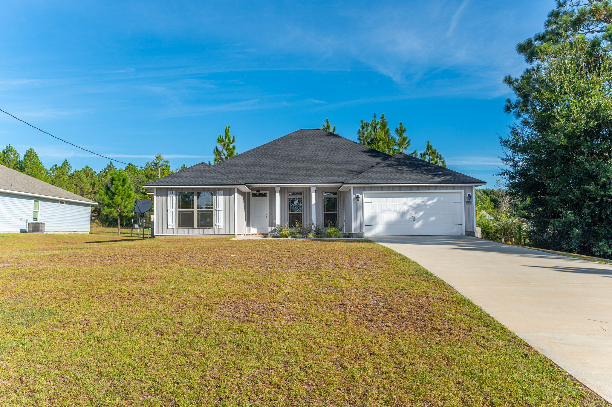 10152 American Farms Road Milton, FL 32583 - Photo 3 of 49 a front view of a house with a garden