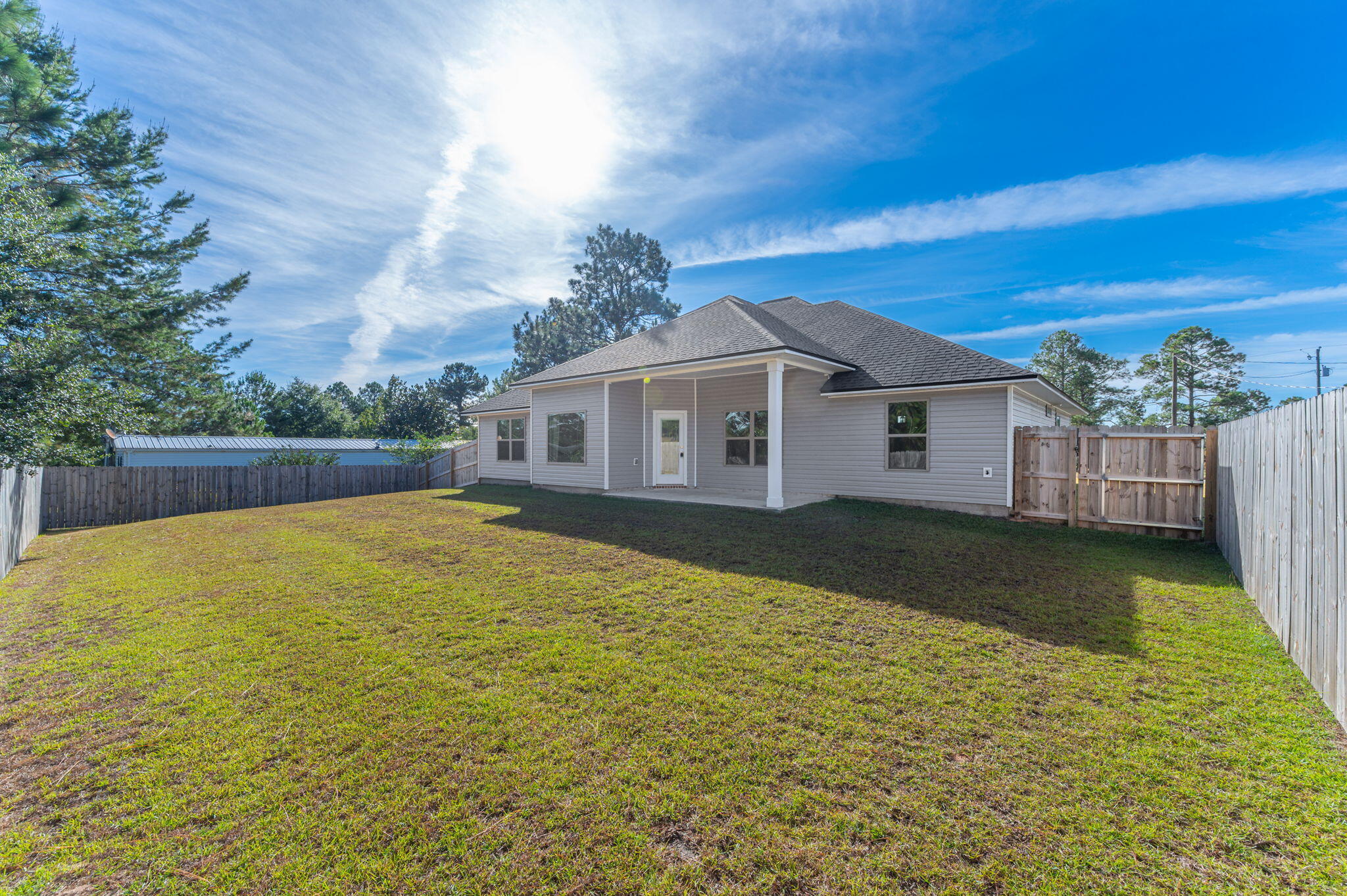 10152 American Farms Road Milton, FL 32583 - Photo 39 of 49 a view of a house with a yard
