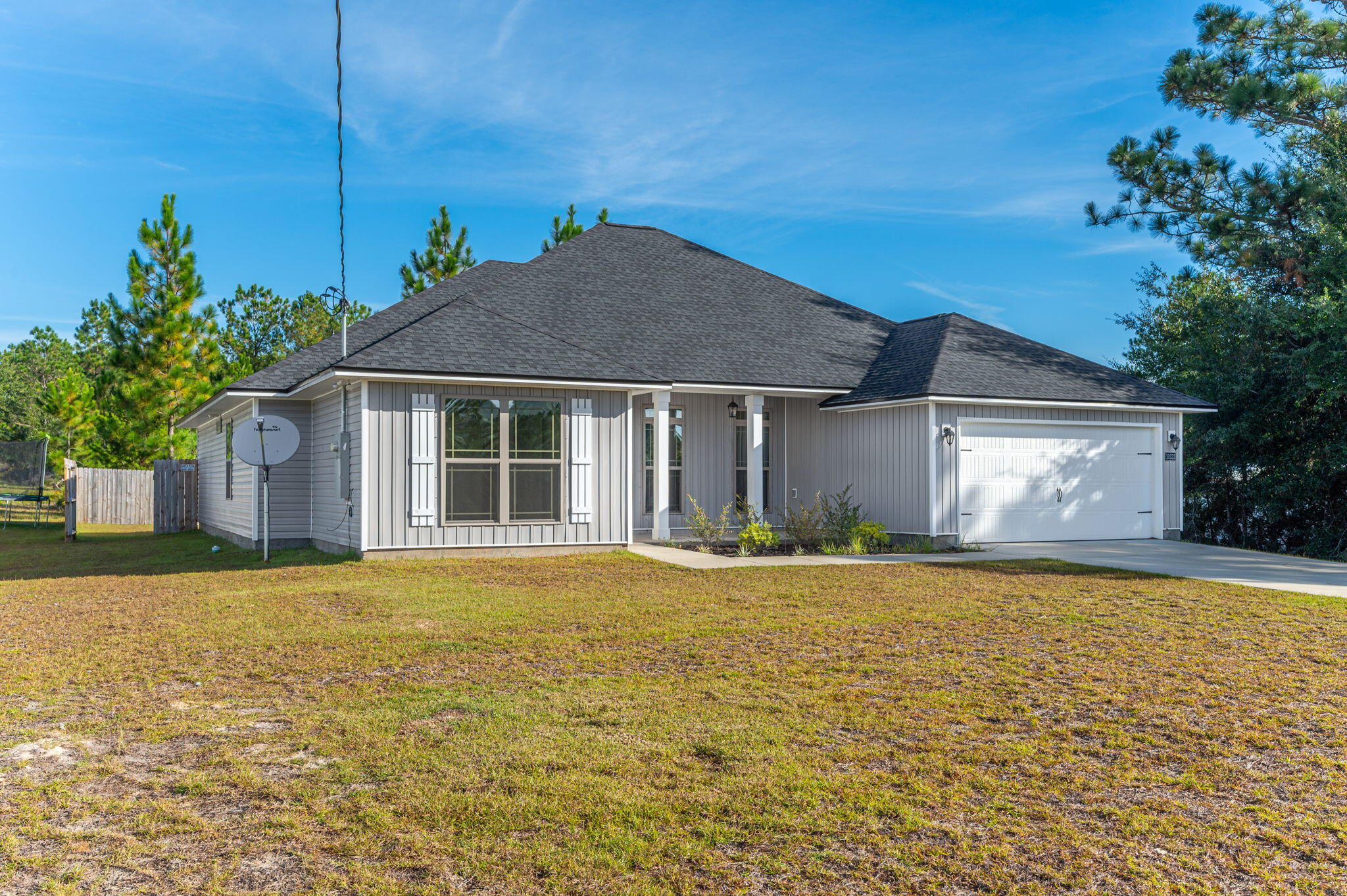 10152 American Farms Road Milton, FL 32583 - Photo 6 of 49 a front view of a house with a garden and yard
