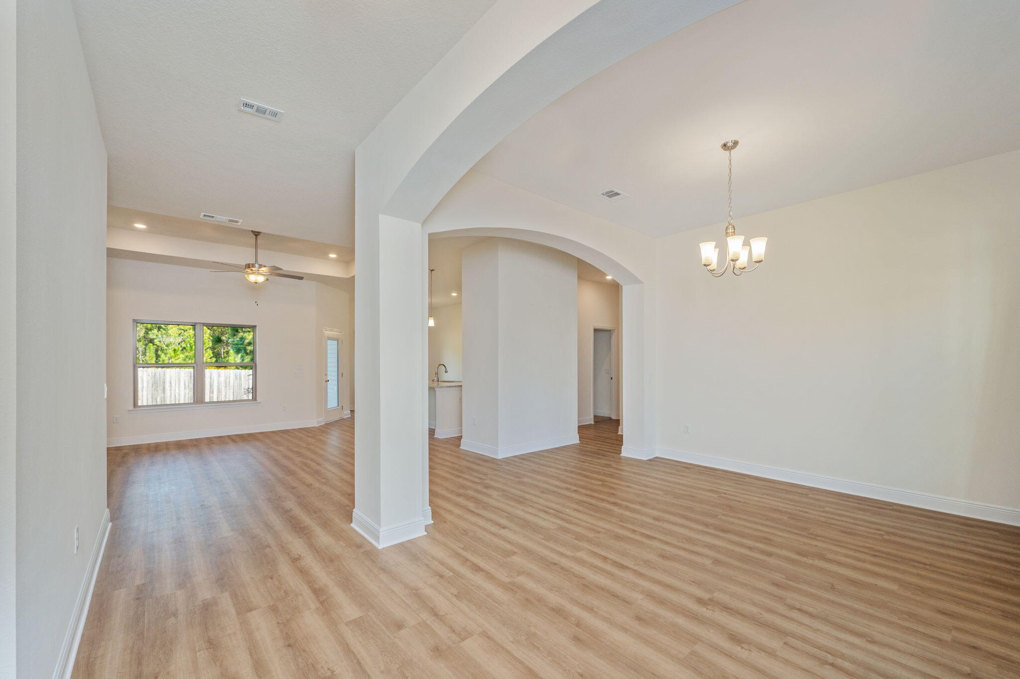 10152 American Farms Road Milton, FL 32583 - Photo 8 of 49 a view of empty room with wooden floor and window
