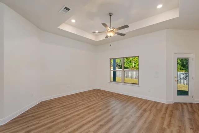 wooden floor in an empty room with a window