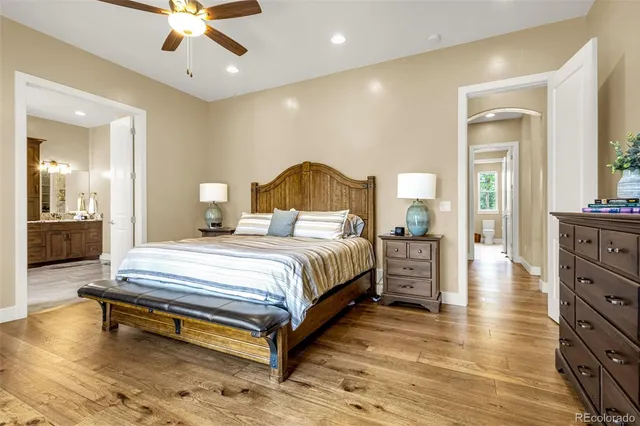 a spacious bedroom with a bed and a chandelier