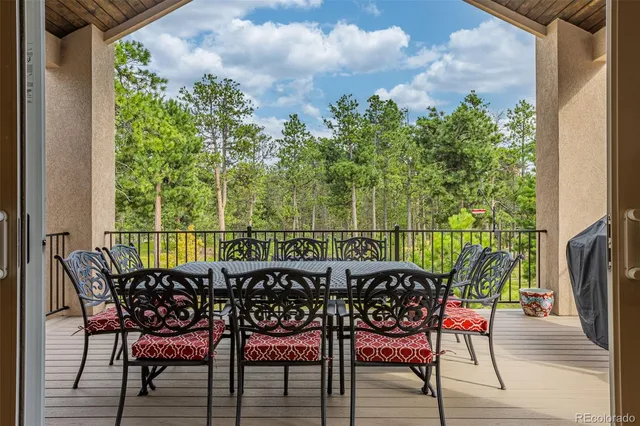 an outdoor sitting area with furniture and wooden floor