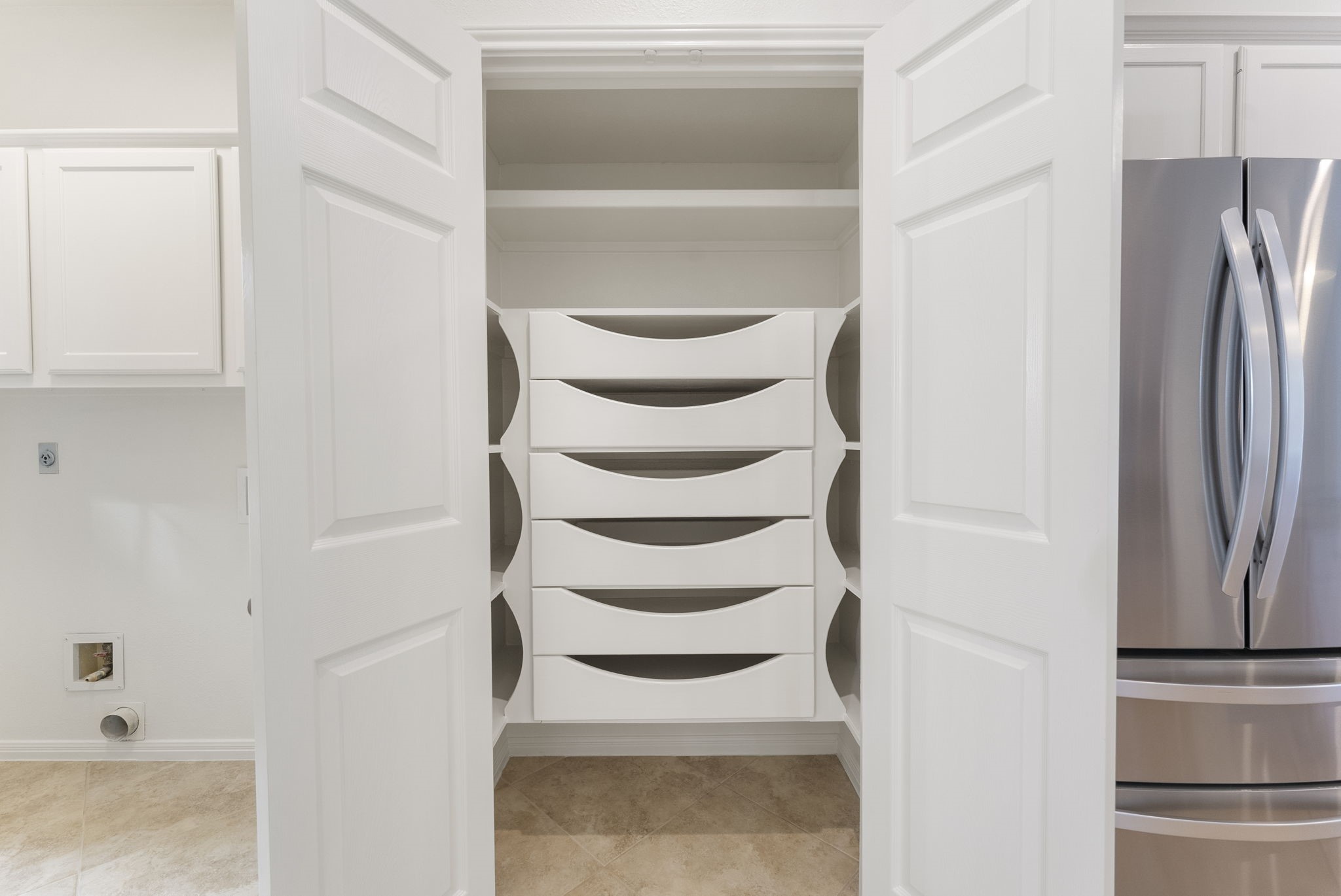 38 North Dragonwood Place Spring, TX 77381 - Photo 12 of 50 The pantry is equipped with pull out drawers. Separately, there is a wall of spice racks (Not shown on the photo)