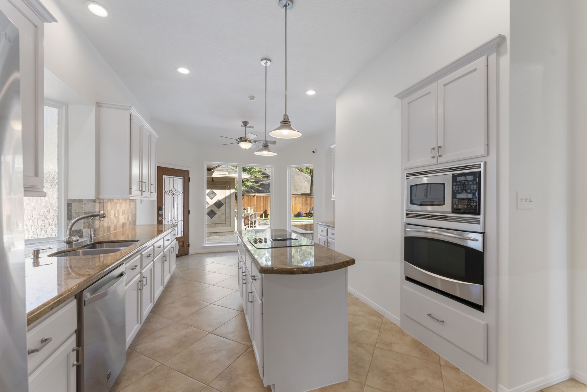 38 North Dragonwood Place Spring, TX 77381 - Photo 9 of 50 Galley-style kitchen equipped with stainless steel appliances.