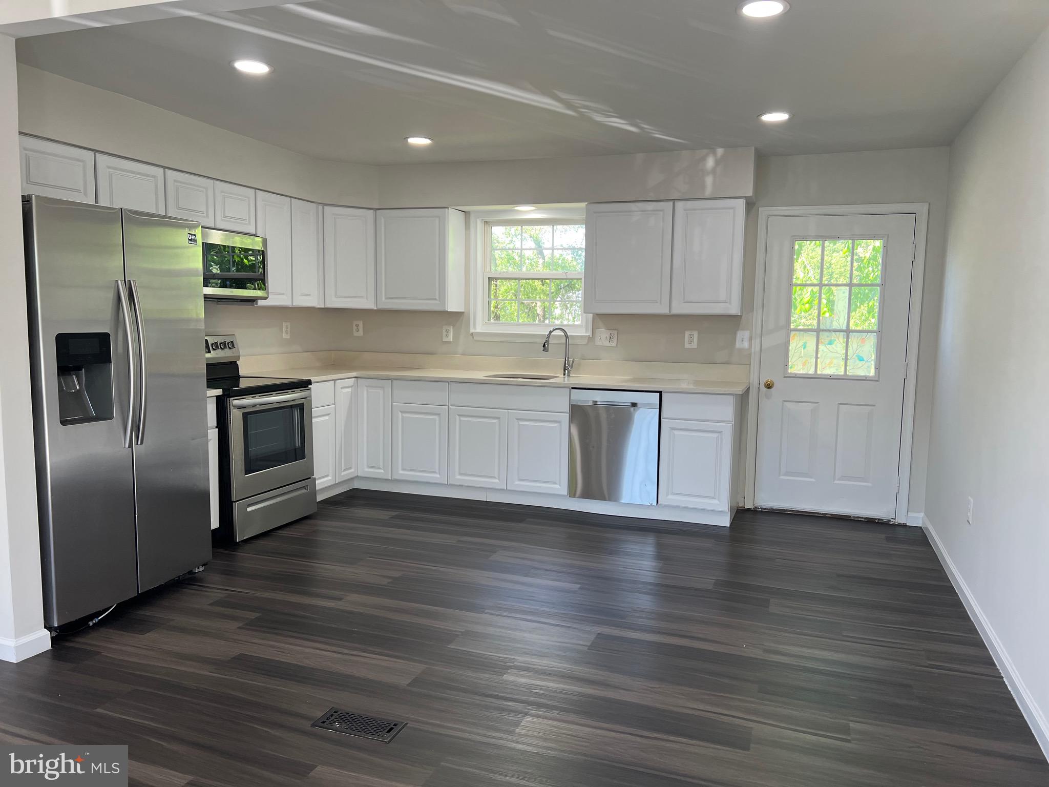 6604 Suitland Road Suitland, MD 20746 - Photo 16 of 27 a kitchen with granite countertop a refrigerator and a sink