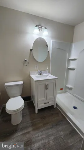 a bathroom with a sink toilet a mirror and bathtub