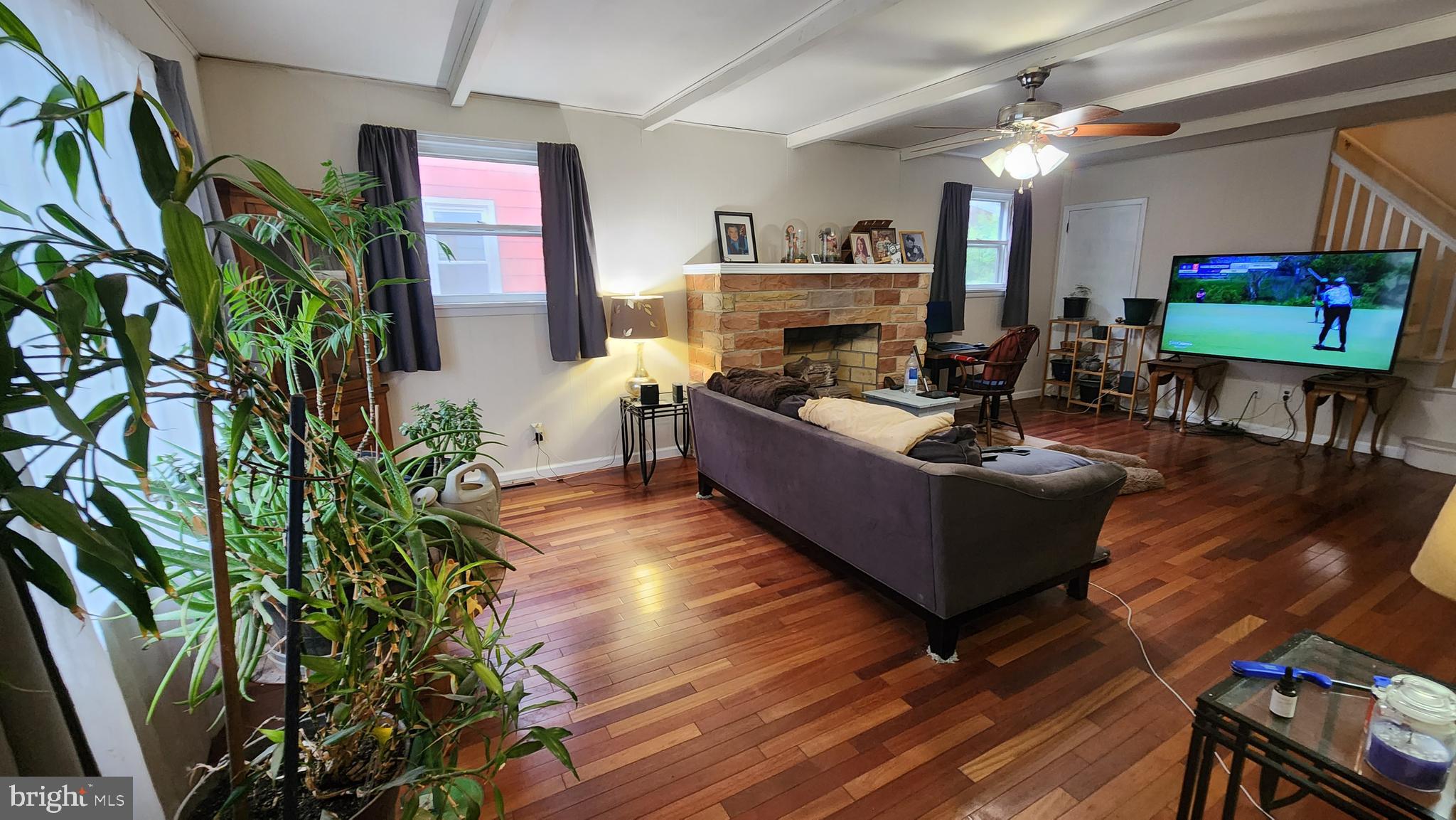 407 West High Street Glassboro, NJ 08028 - Photo 2 of 14 a living room with furniture a fireplace and a flat screen tv