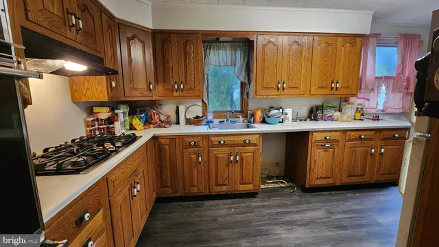 a kitchen with a sink stove and cabinets