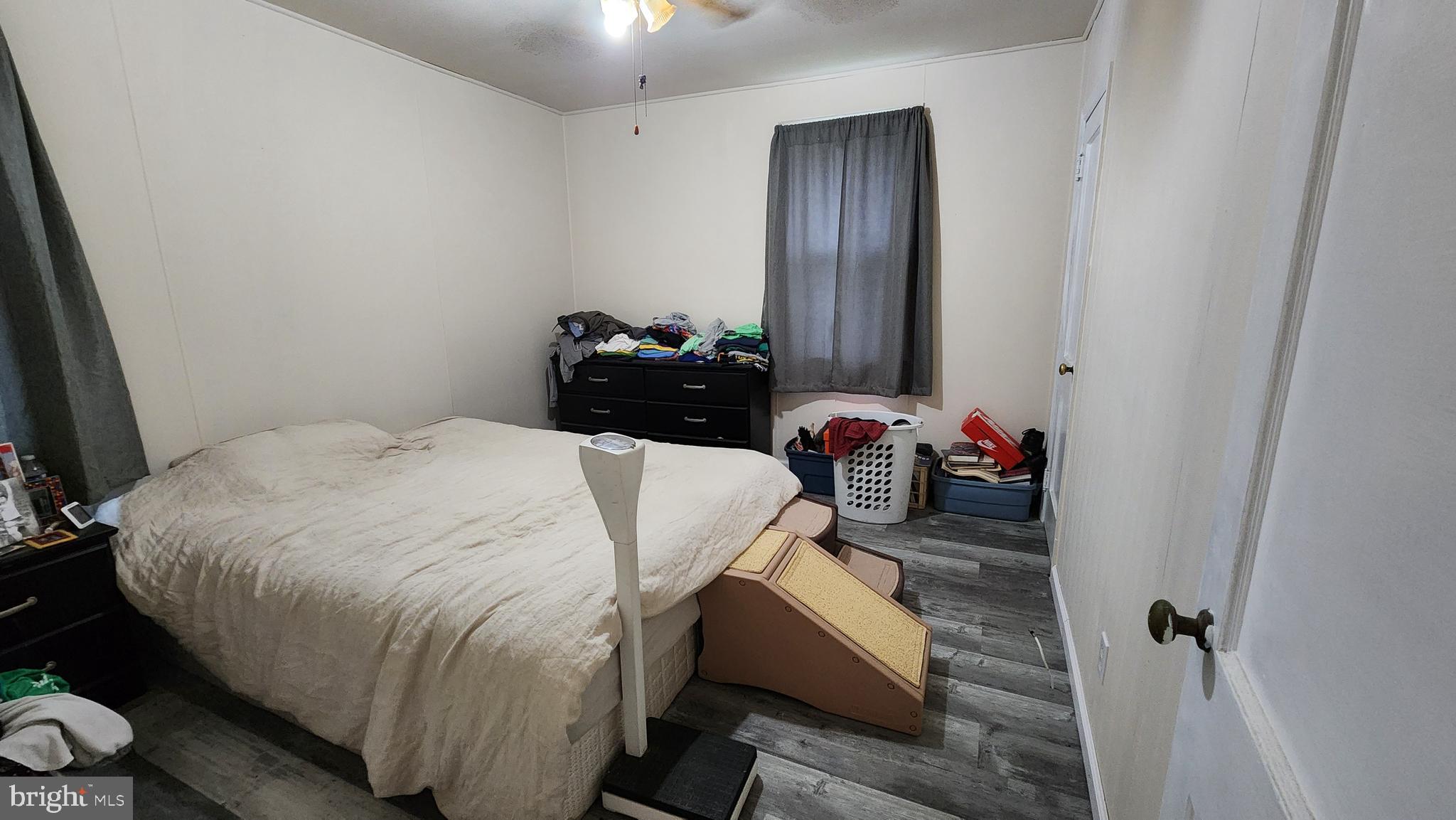 407 West High Street Glassboro, NJ 08028 - Photo 9 of 14 a bedroom with a bed and a mirror
