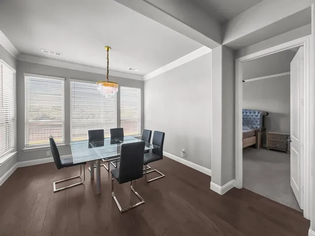 a view of a livingroom with furniture and floor to ceiling window