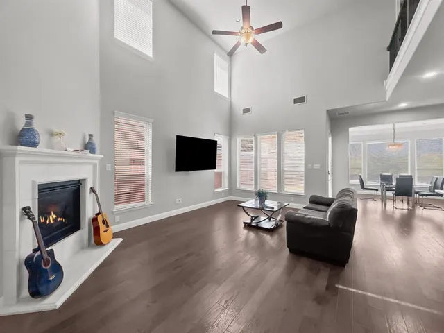 a living room with furniture floor to ceiling window and a fireplace