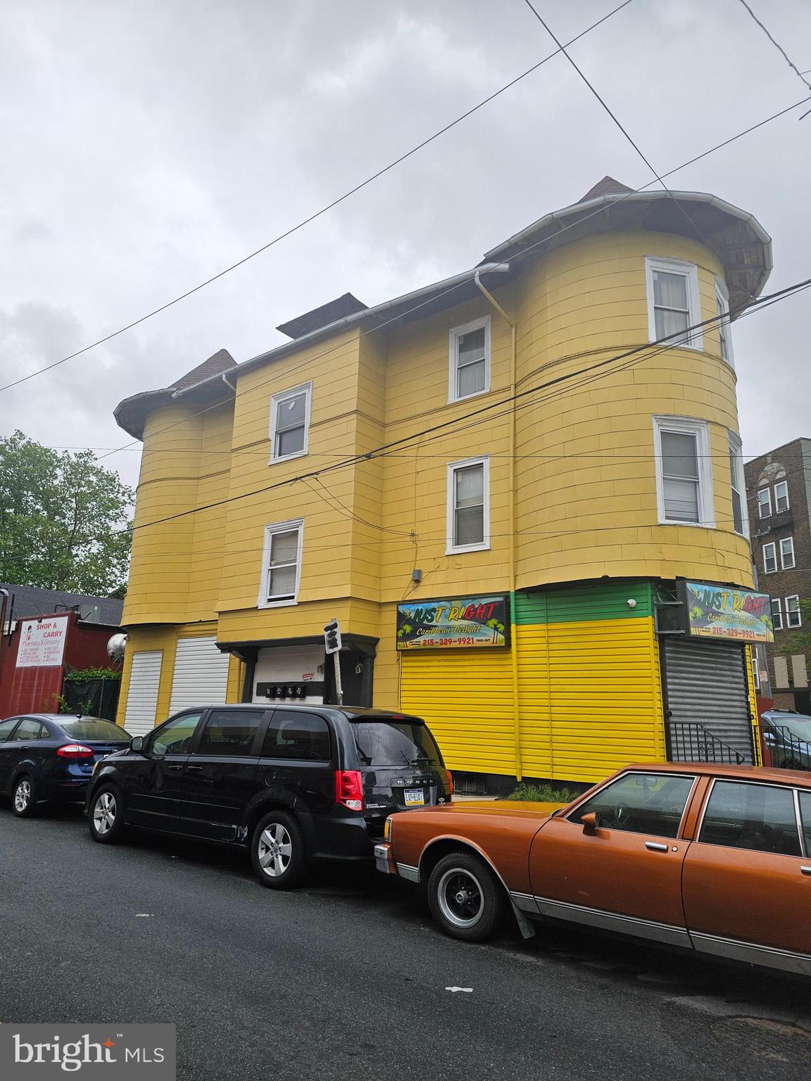 1322 Windrim Avenue Philadelphia, PA 19141 - Photo 1 of 14 a car parked in front of a yellow house
