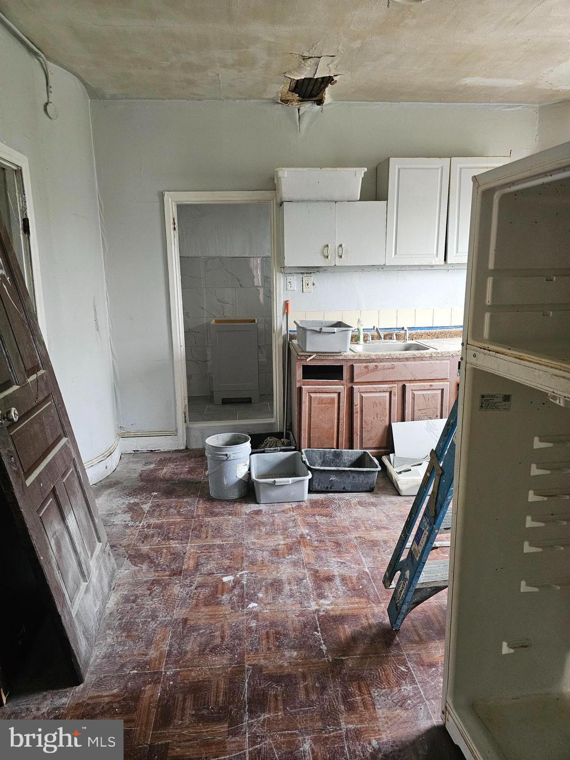 1322 Windrim Avenue Philadelphia, PA 19141 - Photo 9 of 14 a kitchen with stainless steel appliances granite countertop a stove refrigerator and cabinets