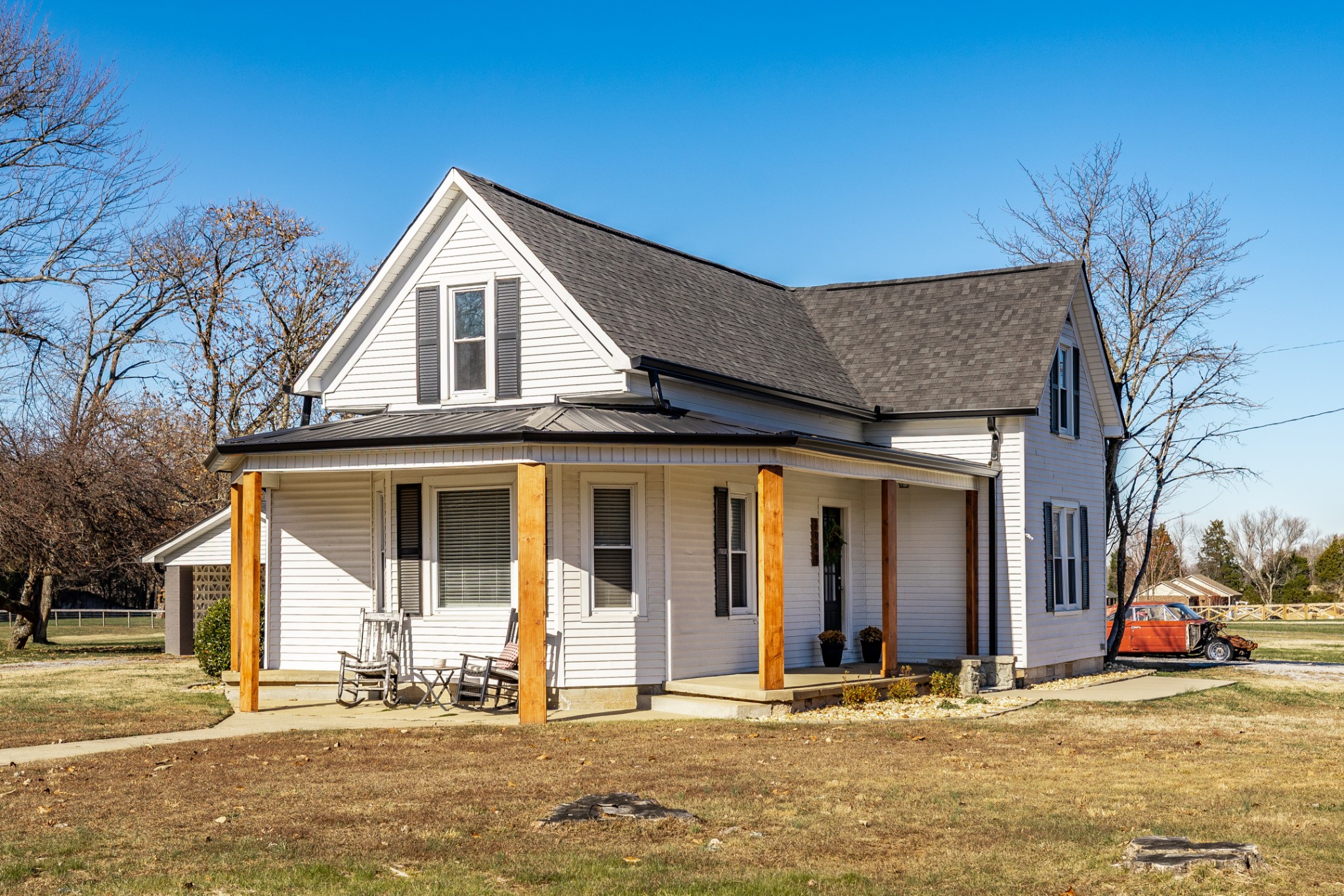 a view of a house with a patio and a yard