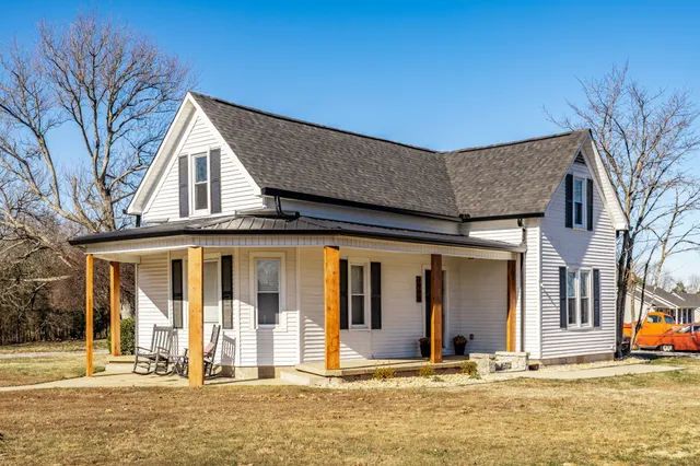 a view of a white house with large windows