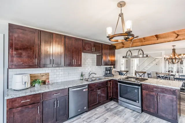a kitchen with a sink a stove and cabinets