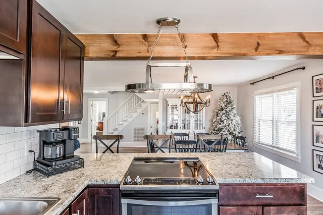 a kitchen with granite countertop a sink and a stove