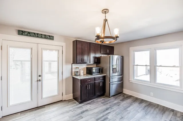 a kitchen with stainless steel appliances granite countertop a refrigerator and a stove top oven